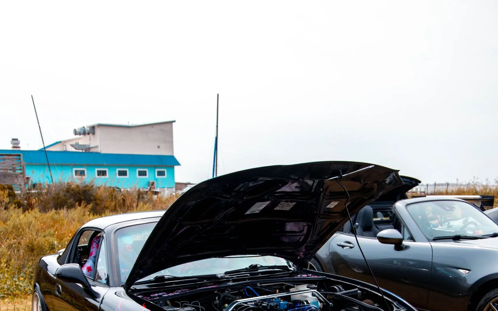 Modified Japanese performance car with hood open showing the engine bay